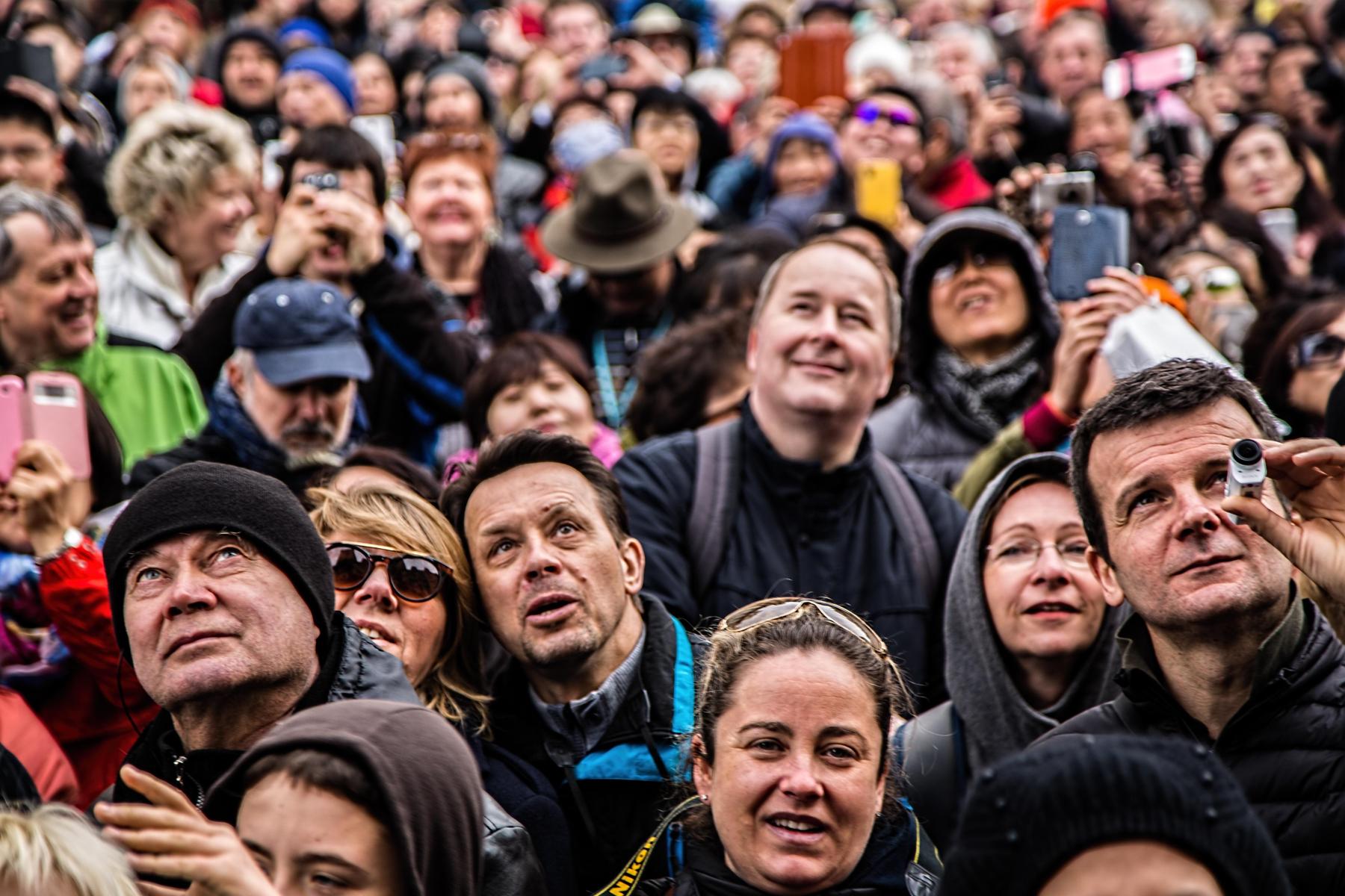 People in a crowd looking up.